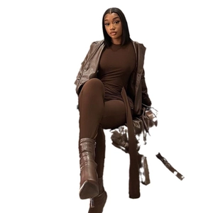 Women's dark brown long PU leather trench coat with matching bodysuit and pointed boots