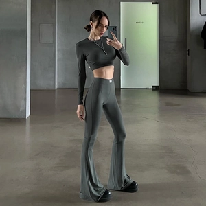 Detail of dark grey-green yoga set with long sleeve crop top and flared leggings