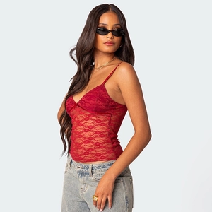 Detail of red lace V-neck tank top with bow and sheer mesh floral pattern texture