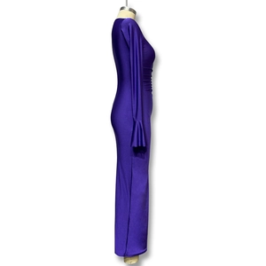 Detail view of flared cuffs and side pleats on a slim fit dark purple maxi dress