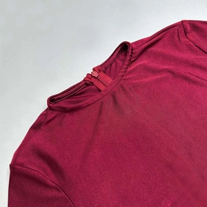 Macro view of the high neck design and hidden zipper detail on the burgundy slim dress