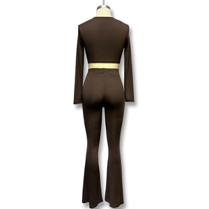Back view of dark brown long sleeve crop top and high waisted flare pants set