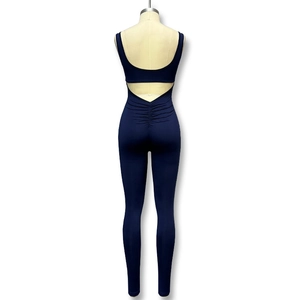 Detail showing back cutout design and ruched butt lifting seam on navy sports jumpsuit