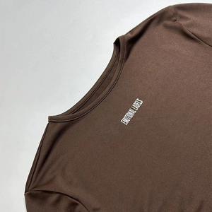 Detail of coffee brown round neck top showing the EMOTIONAL LABELS print texture