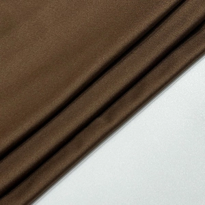 Gros plan sur un tissu en maille marron avec texture lisse et plis diagonaux