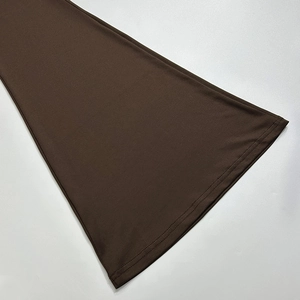 Detailed close-up of dark brown fabric hem with professional double-needle stitching quality