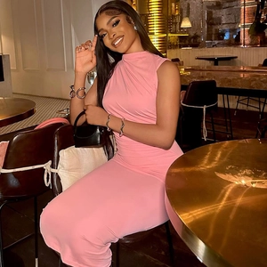 Detail of a pink sleeveless slim-fit maxi dress featuring a high-neckline and tailored cut
