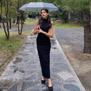 Elegant sleeveless black maxi dress featuring a high neckline and fitted silhouette