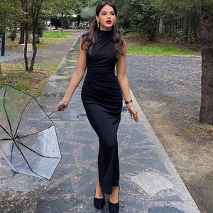 Detailed view of the waist ruching and side pleats on the black sleeveless maxi dress