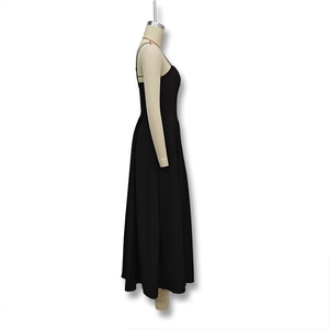 Detail view of the sleek A-line silhouette and smooth black fabric of the backless maxi dress
