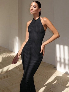 Detail of black halter neck knitted dress featuring vertical rib texture and a slim fit