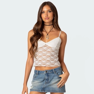 Detail of white lace V-neck camisole with bow and floral translucent mesh panels