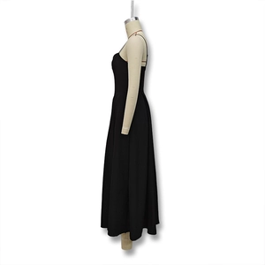 Detail showing the elegant backless design and A-line waist of this black maxi dress