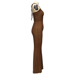Detailed view of the brown knitted cutout texture and halter neck design on long dress