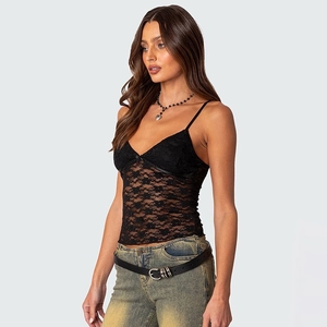 Detail of black lace camisole featuring floral patterns and a small bow on V-neckline
