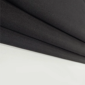 Close-up detail of high-quality black plain weave fabric for the sexy backless dress