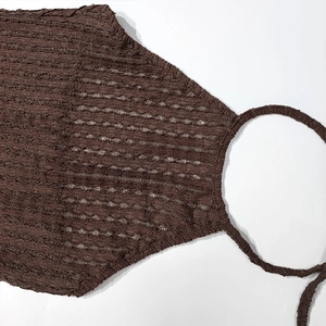Detailed view of dark brown crinkle seersucker knit fabric on a halter neck dress