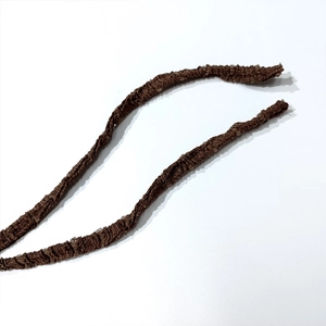 Detailed close-up of brown textured knitted drawstring on an elegant backless maxi dress