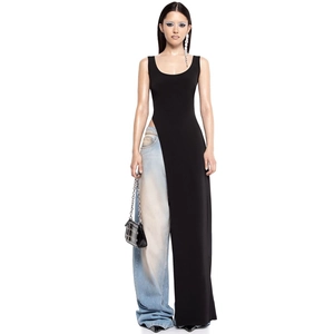 Detail view of a black high-slit sleeveless top paired with light blue wide-leg jeans