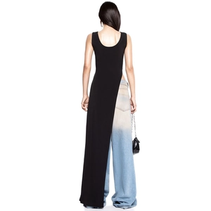 Rear view of long asymmetric black top with floor-length hem and baggy gradient jeans