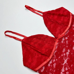 Detailed view of red lace tank top featuring a delicate satin bow and floral embroidery