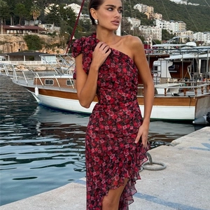 Detail of floral print asymmetrical dress with ruffle hem and one-shoulder cut on model