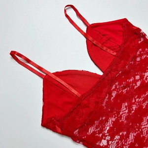Close-up of red lace camisole showing floral texture and delicate spaghetti straps