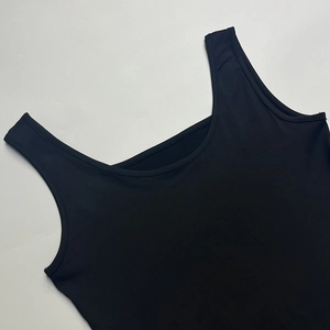 Close-up of double-stitched hem on a black U-neck sleeveless slim fit tank top shirt