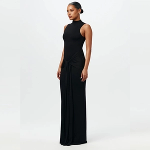 Detail view of the elegant ruched knot and draped texture on this black slim maxi dress
