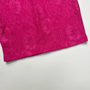 Gros plan sur le tissu en dentelle florale magenta avec broderie détaillée