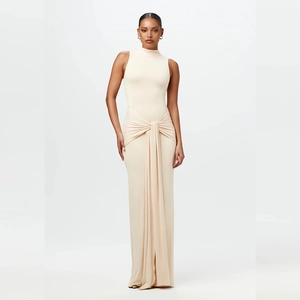 Detail of waist tie-dye twist and elegant draping on sleeveless beige maxi dress