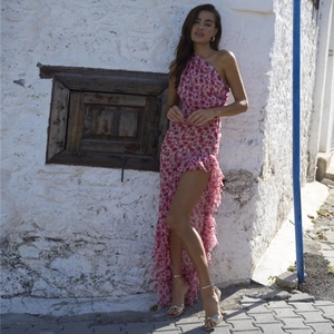 Detail of red floral one-shoulder dress with ruffled hem and bohemian chiffon texture