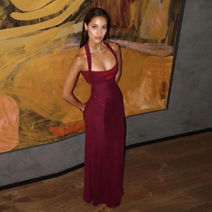 Detail of burgundy halter neck maxi dress with slim fit design and subtle glossy finish