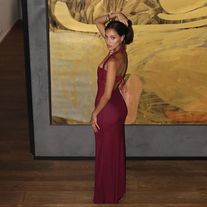 Detail of burgundy backless halter dress showing slim fit silhouette and tie-back design
