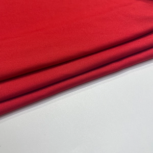Detailed view of red ribbed knit fabric texture showing vertical stripes and soft material