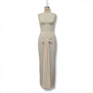 Detailed view of the waist ruching and decorative drape on a beige sleeveless dress