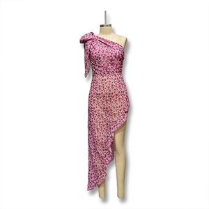 Detail view of floral one-shoulder dress with ruffled hem and bow on the shoulder strap