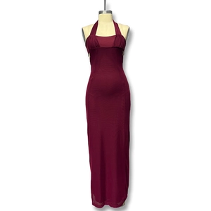 Detail of burgundy halter neck dress featuring ruched chest and slim fit floor-length cut