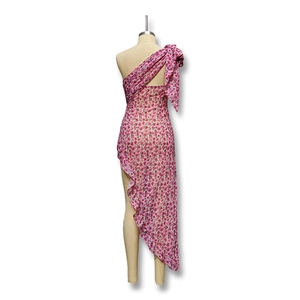 Detail view of the pink floral one-shoulder dress with a large shoulder bow and ruffles