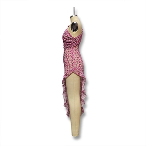 Detail of pink floral dress featuring side drawstrings and asymmetrical ruffled hemline