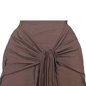 Detail view of deep brown stretch fabric with decorative central knot and pleated texture