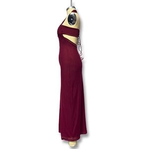 Detail of burgundy halter mesh dress featuring side cut-outs and elegant criss-cross tie back