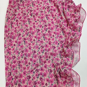 Detail of pink floral chiffon fabric featuring elegant ruffles and lightweight texture