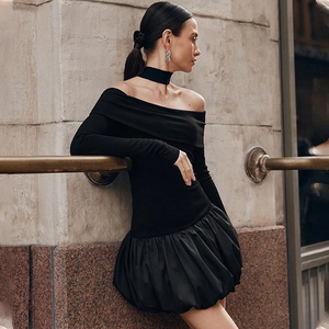 Detailed view of black off-shoulder puff dress with long sleeves and a trendy bubble skirt