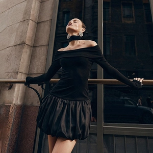 Close-up of off-the-shoulder long sleeve dress with a stylish puff bubble skirt detail