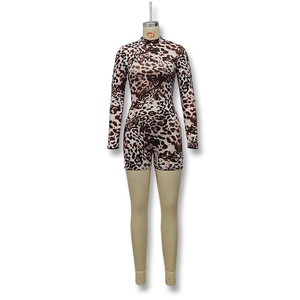 Close-up of leopard print fabric with mock neck and long sleeve detail on romper