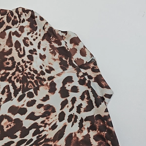 Detailed view of leopard print bodysuit featuring a discrete invisible side zipper closure