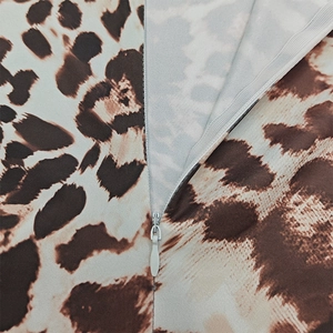 Detailed close-up of a high-quality invisible zipper on a stylish leopard print jumpsuit