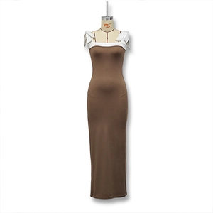 Detail view of brown slim fit maxi dress featuring white contrast piping and bow tie straps