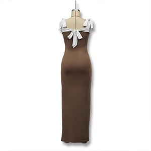 Detail of elegant backless design with large white ribbon bow on slim fit brown dress